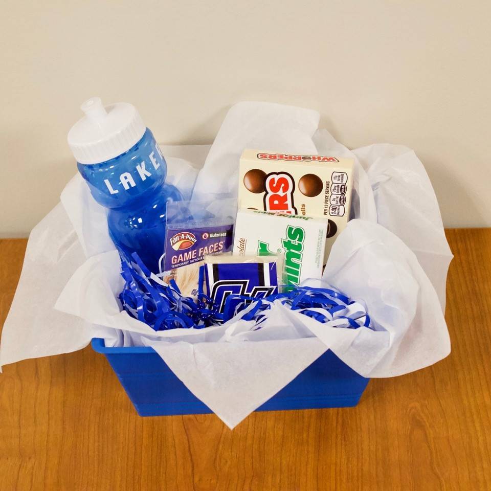 Scavenger hunt prize basket includes a GV water bottle, candy, GV temporary face tattoos, pom poms, a beaded necklace, and GV hand warmers.